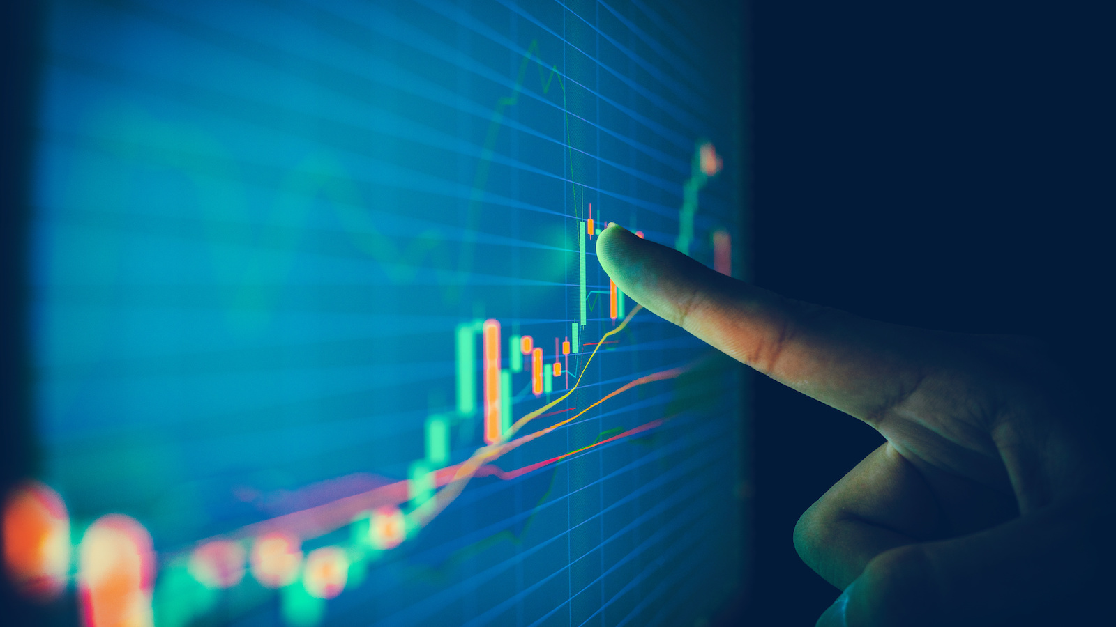 Corporate Agility Closeup hand pointing finger on blue color monitor to analyze stock market graph Corporate Agility Data